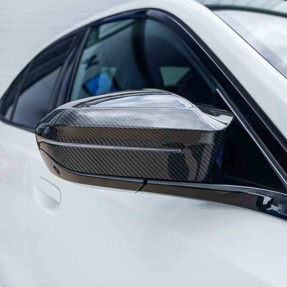 High-gloss carbon fiber side mirror covers in a horn-style design for BMW 5 Series M5 G90 G99 rear-view mirrors.